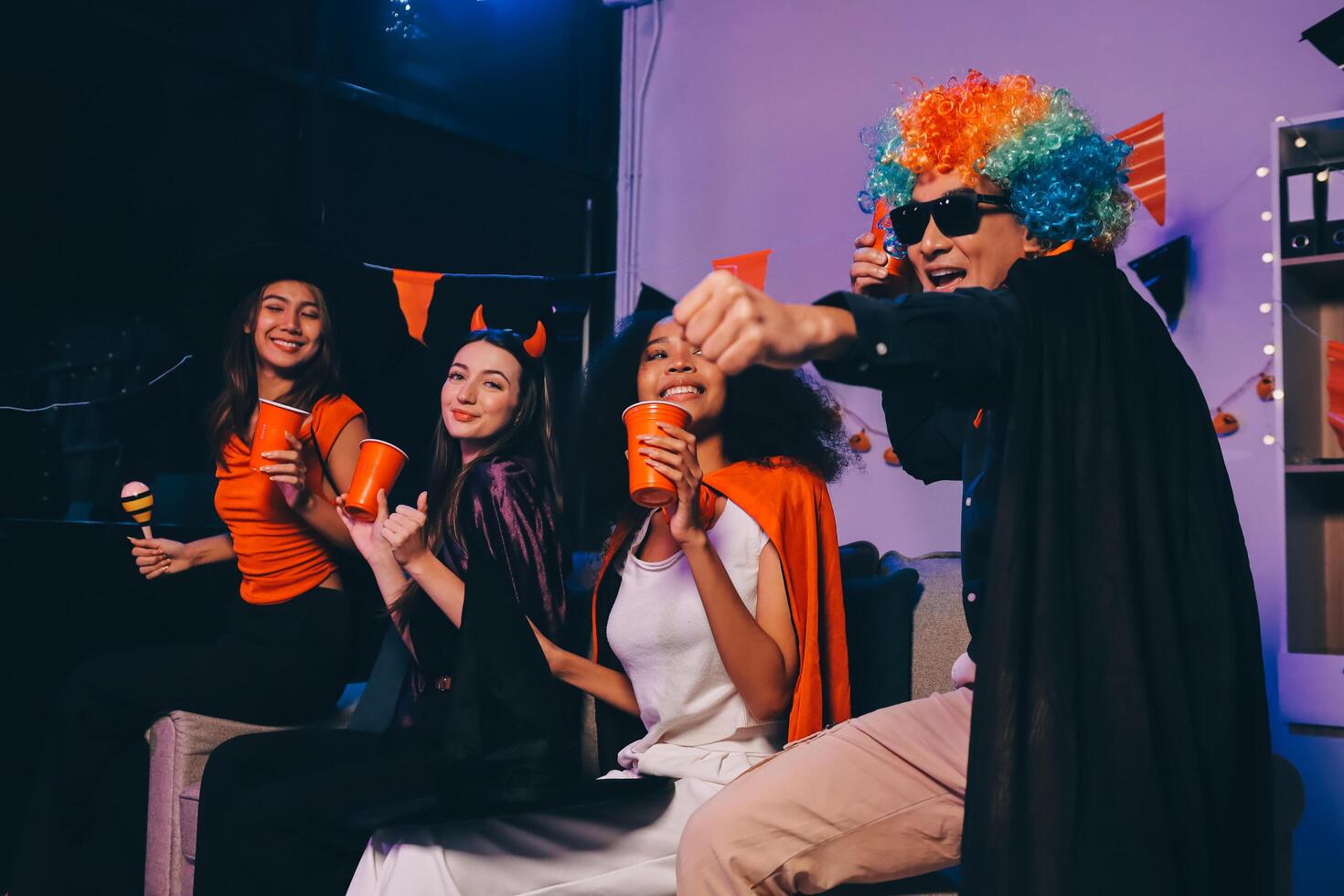 Joyful office Halloween party with coworkers in costumes, celebrating with drinks and laughter, fostering teamwork and festive spirit photo