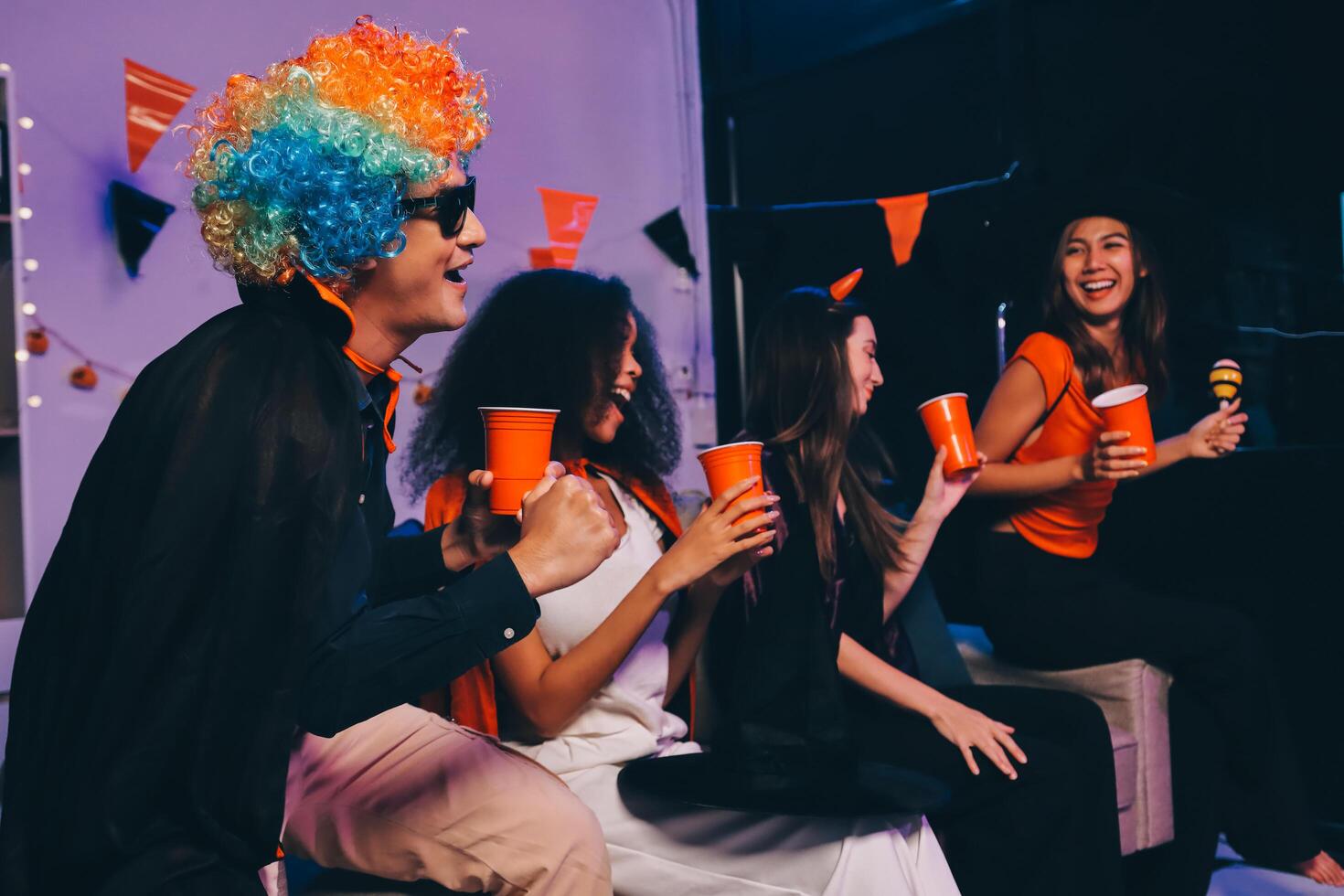 Joyful office Halloween party with coworkers in costumes, celebrating with drinks and laughter, fostering teamwork and festive spirit photo