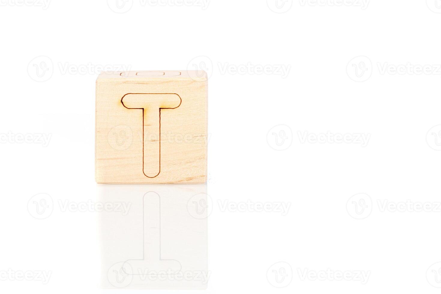 Wooden cubes with letters T on a white background photo