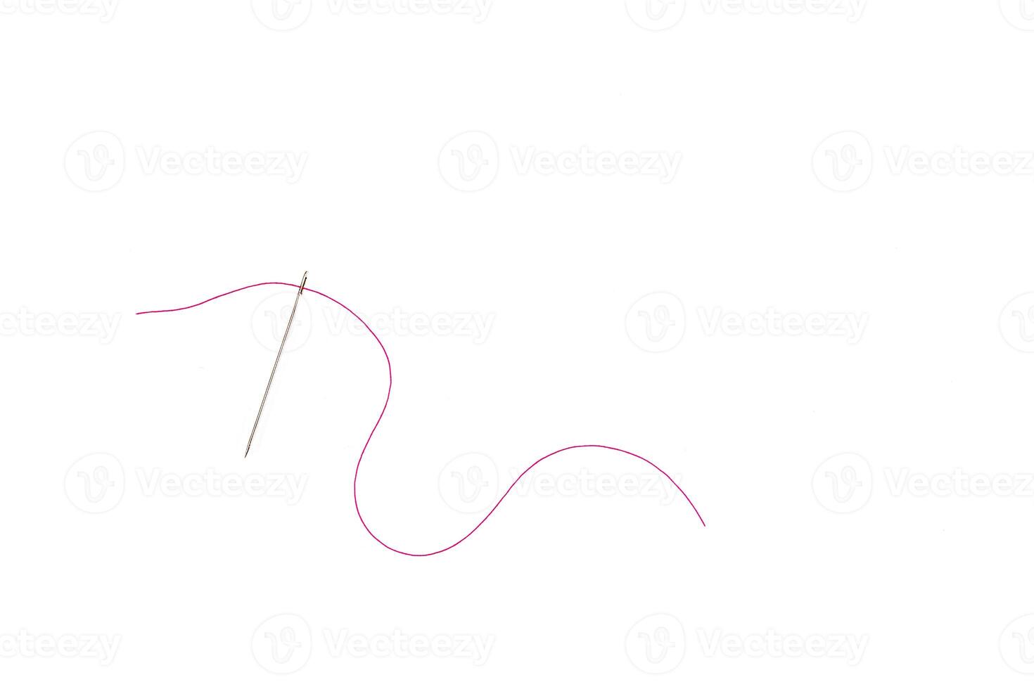 needle and thread of red color on a white background photo