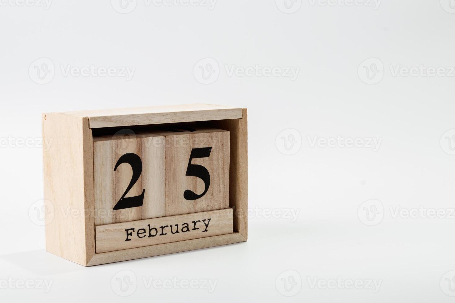 Wooden calendar February 25 on a white background photo