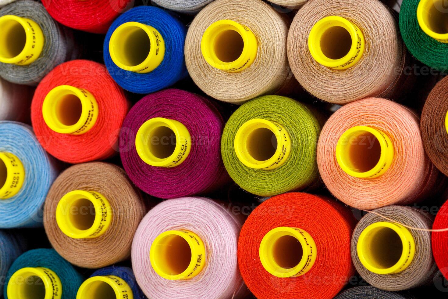 set of multi-colored spools of thread for sewing photo