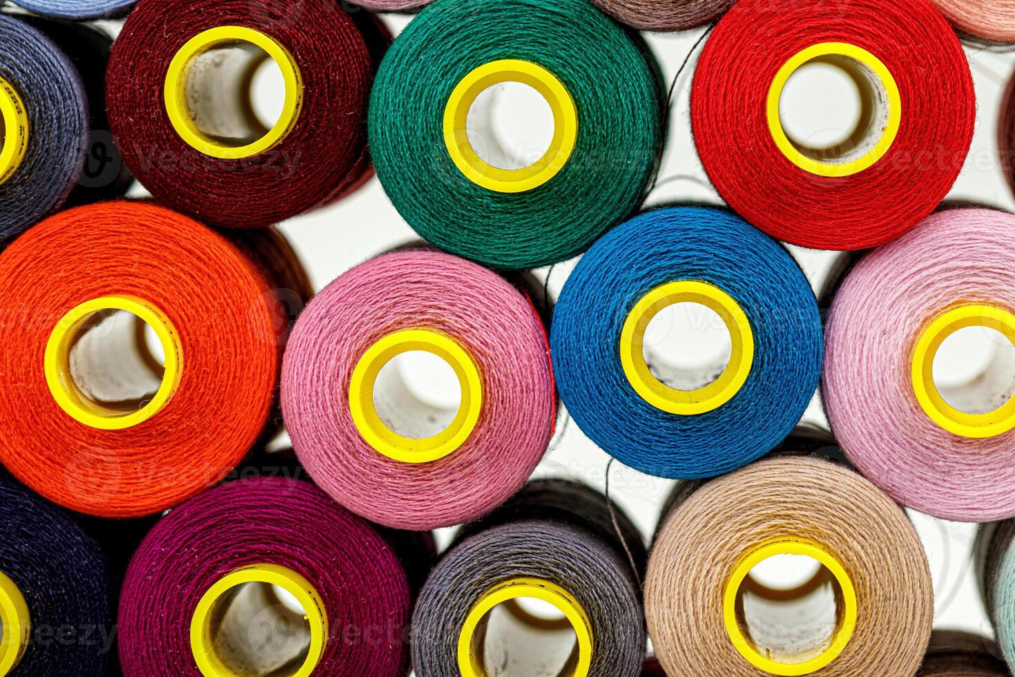 set of multi-colored spools of thread for sewing photo