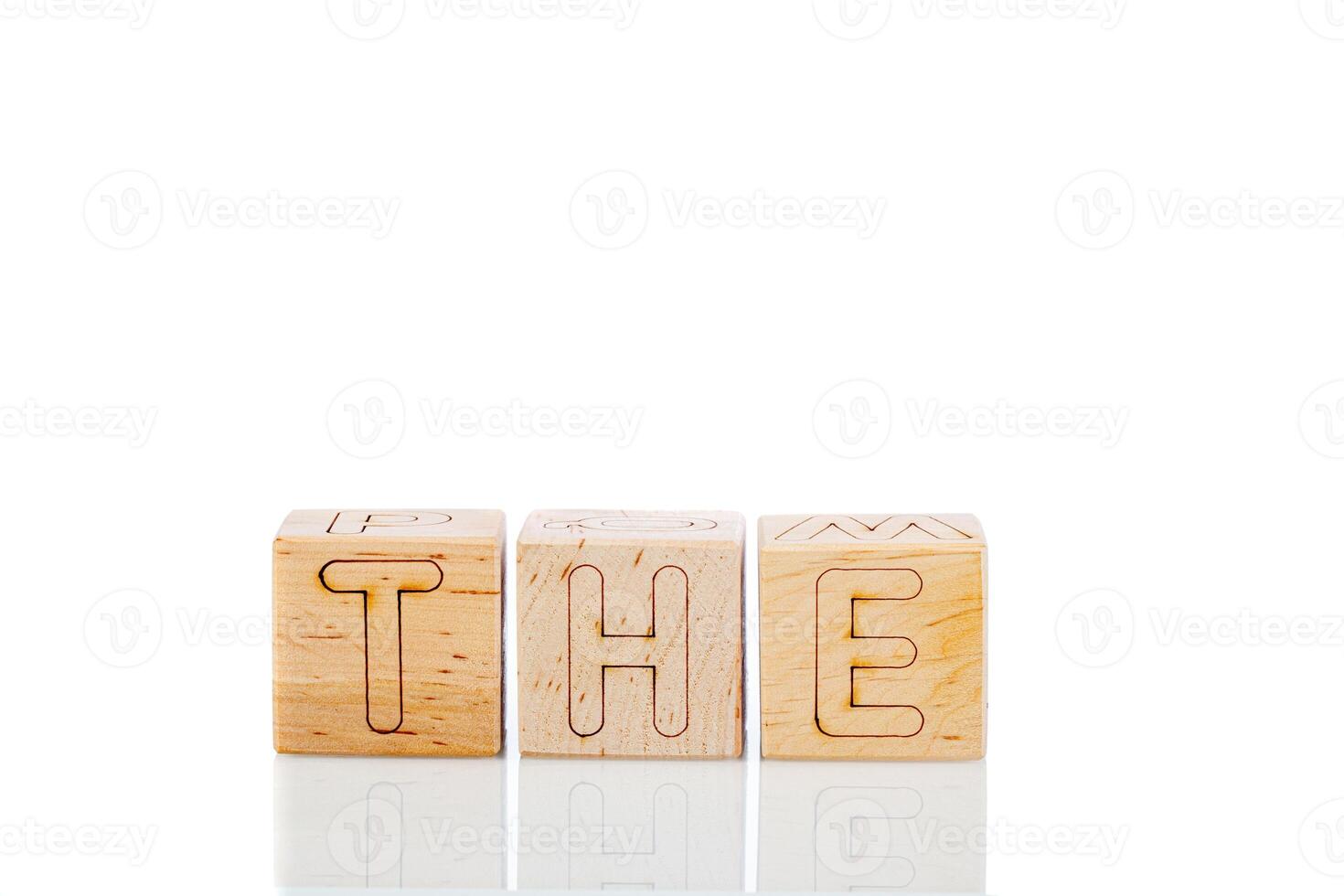 Wooden cubes with letters the on a white background photo