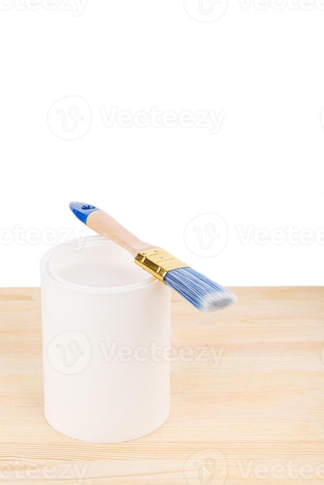 white paint with a brush on a wooden background with texture photo