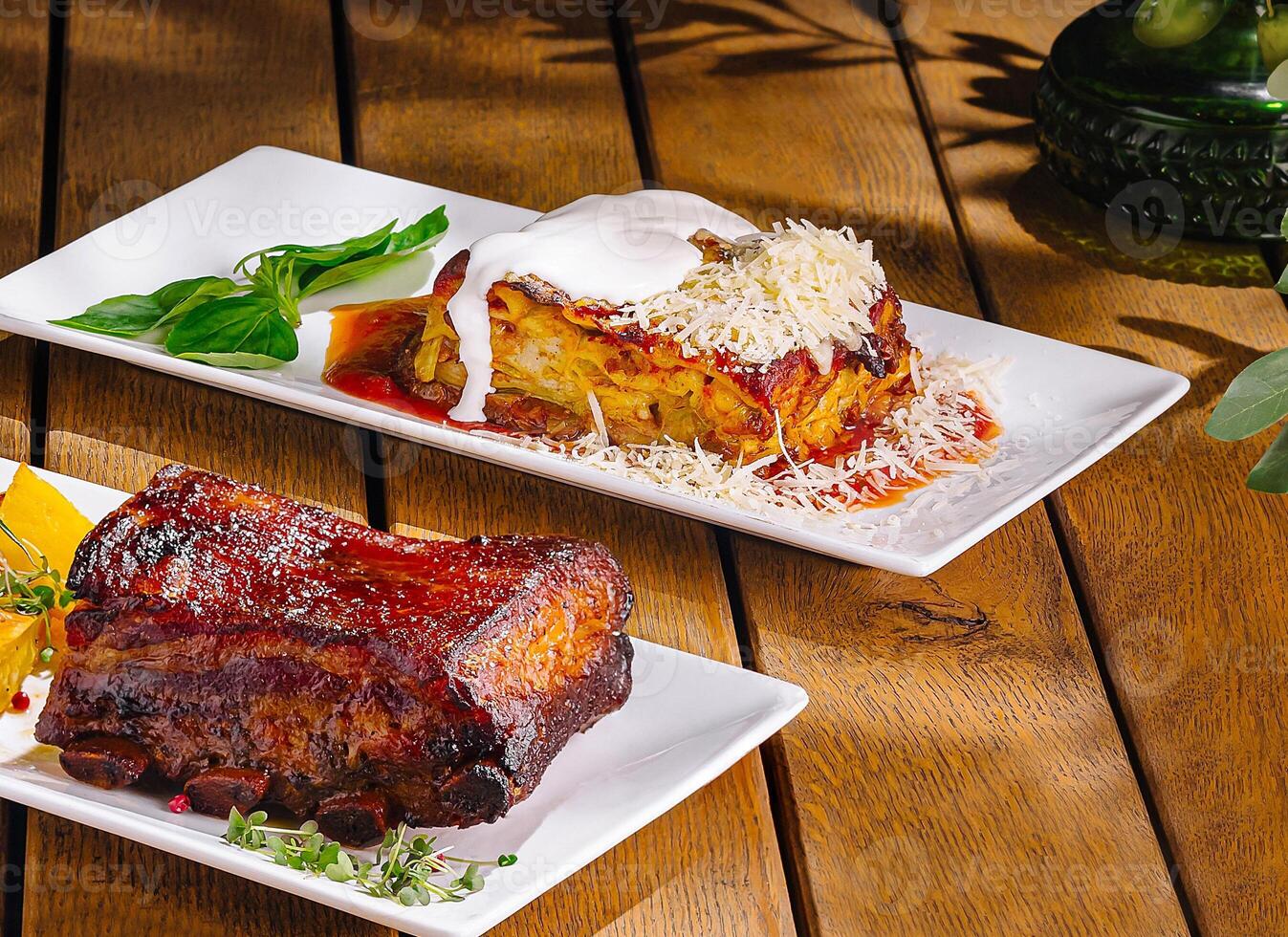 Gourmet feast variety of dishes on wooden table photo