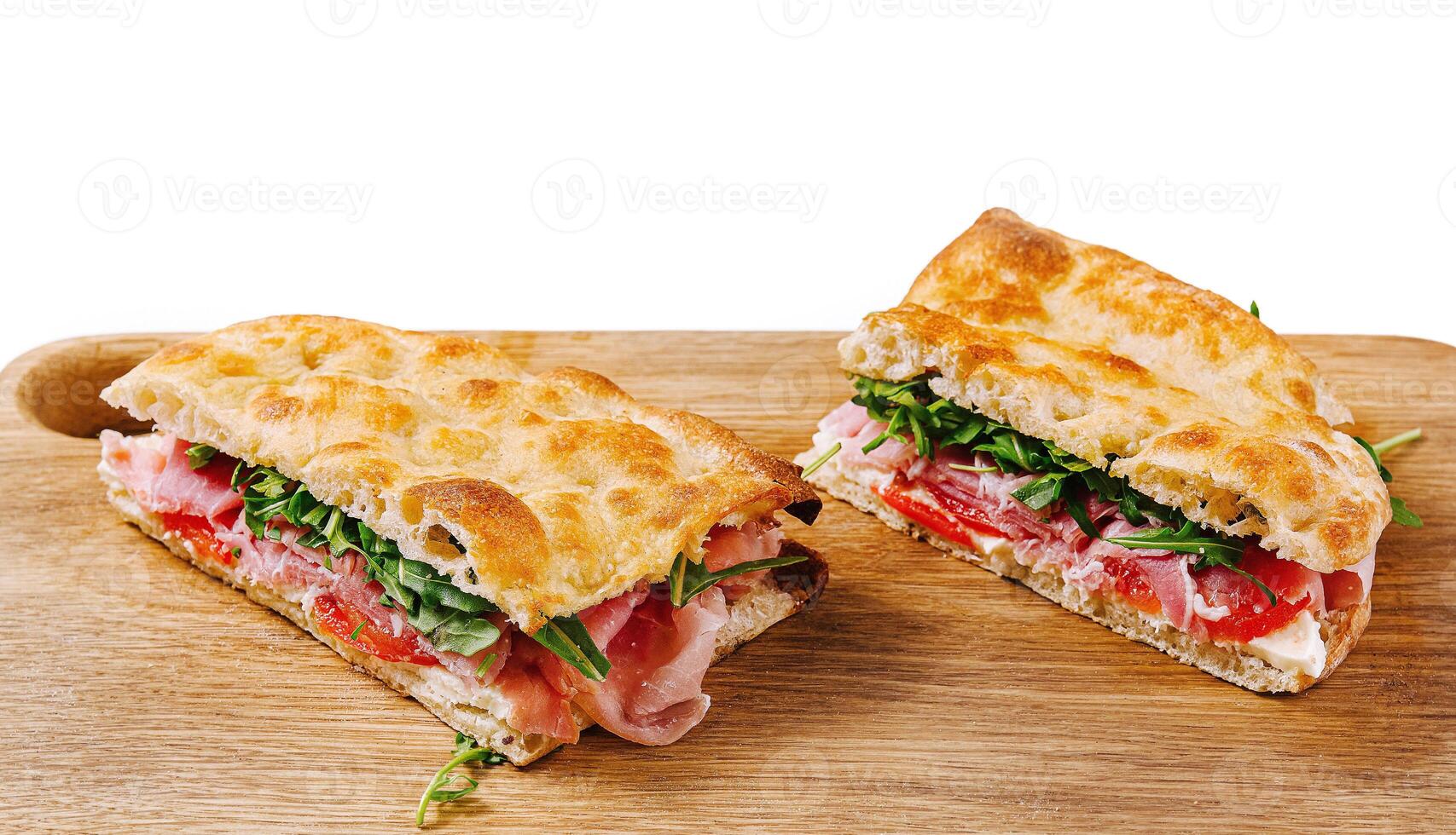 Fresh italian panini sandwich on wooden board photo