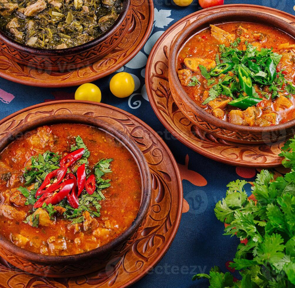 Traditional georgian chanakhi with lamb and vegetables served in clay pots photo