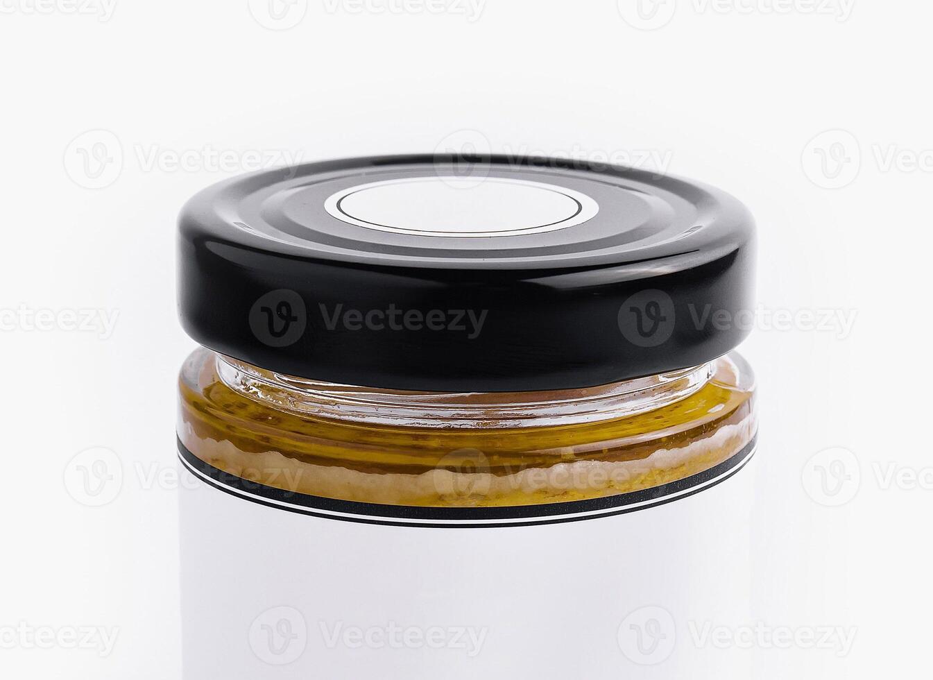 Glass jar with black lid on white background photo