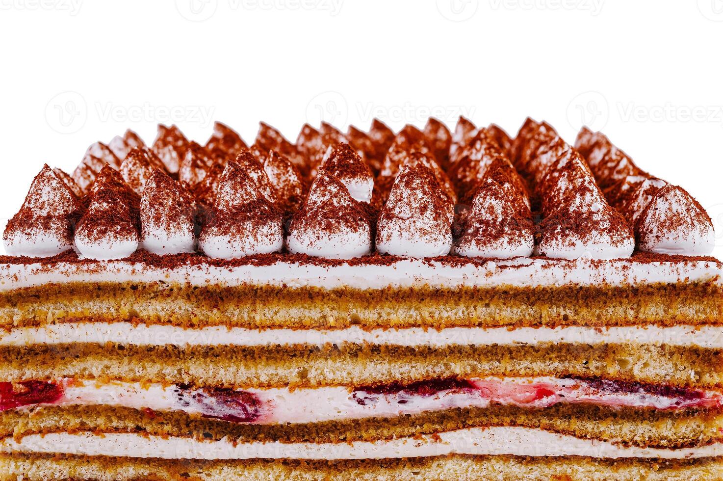 Delicious tiramisu cake with cream and strawberries is being cut into pieces photo
