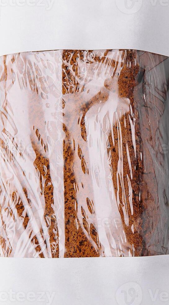 Freshly baked bread wrapped in plastic and paper packaging photo