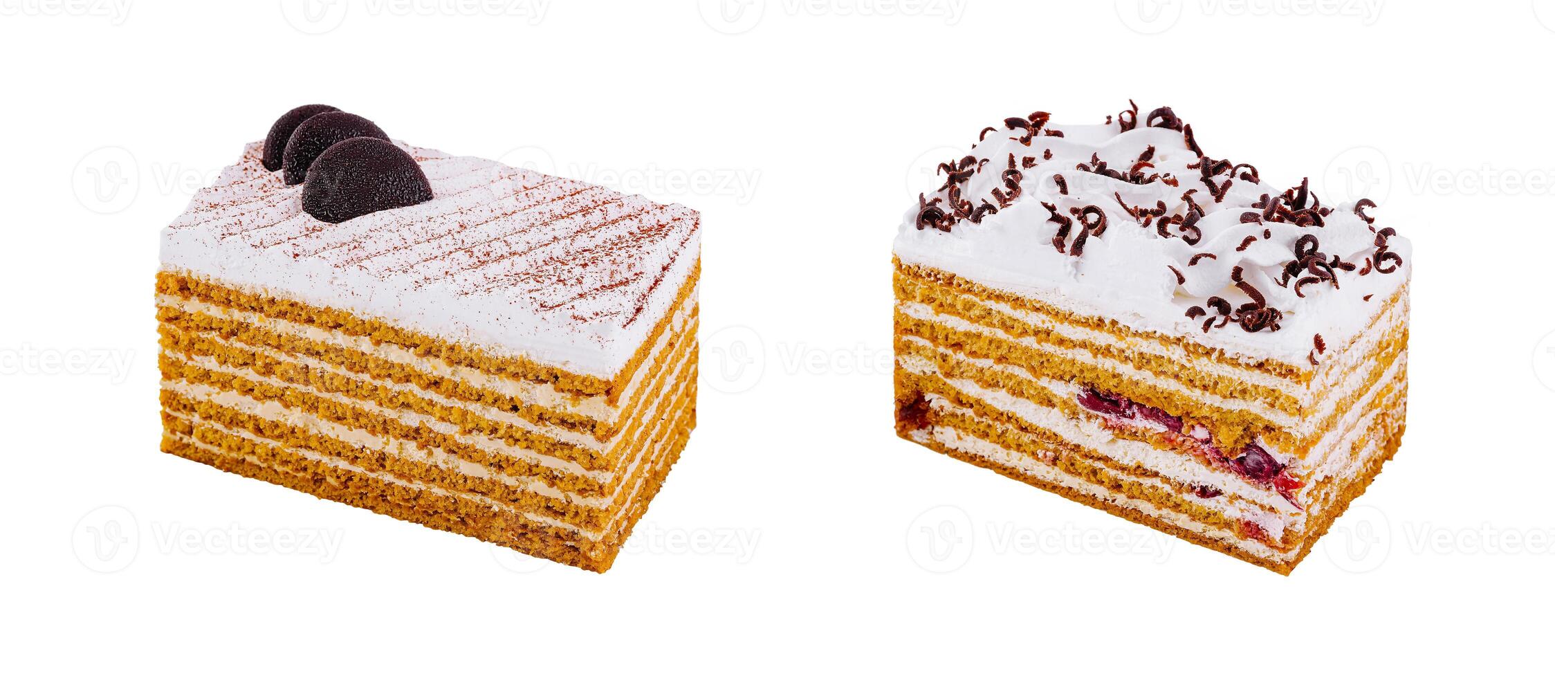 Two honey cake slices decorated with whipped cream and chocolate on white background photo