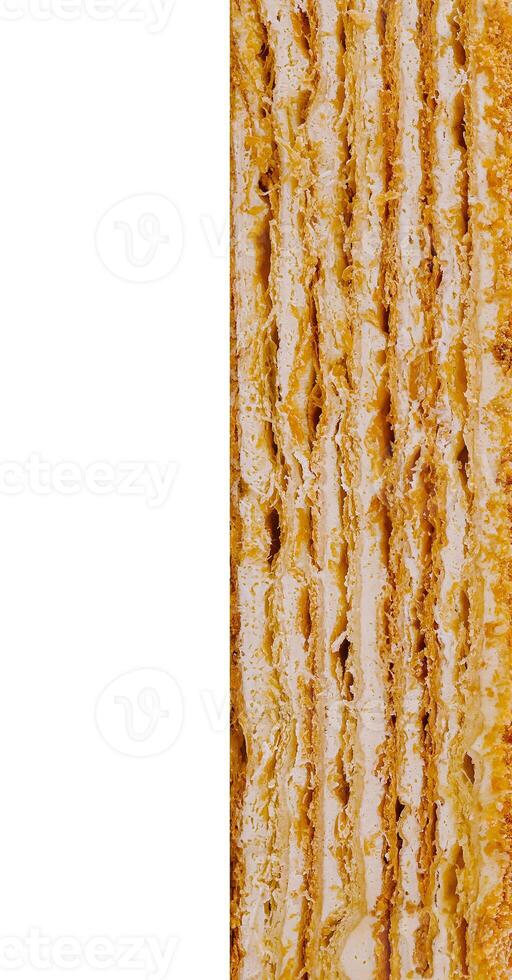 Delicious multi-layered cake with cream filling is showing its texture on white background photo