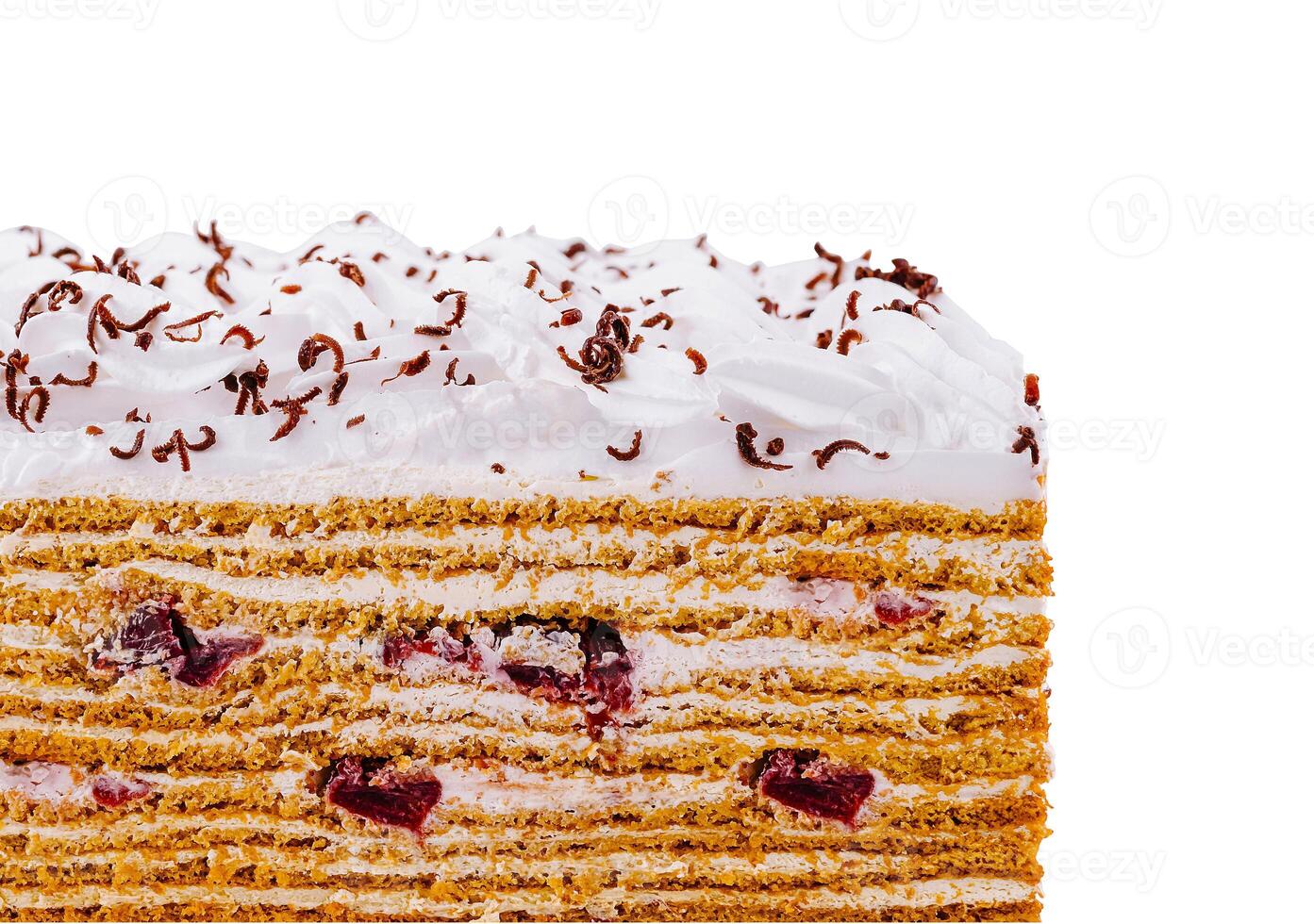 Delicious layered honey cake with cherries and chocolate sprinkles on white background photo
