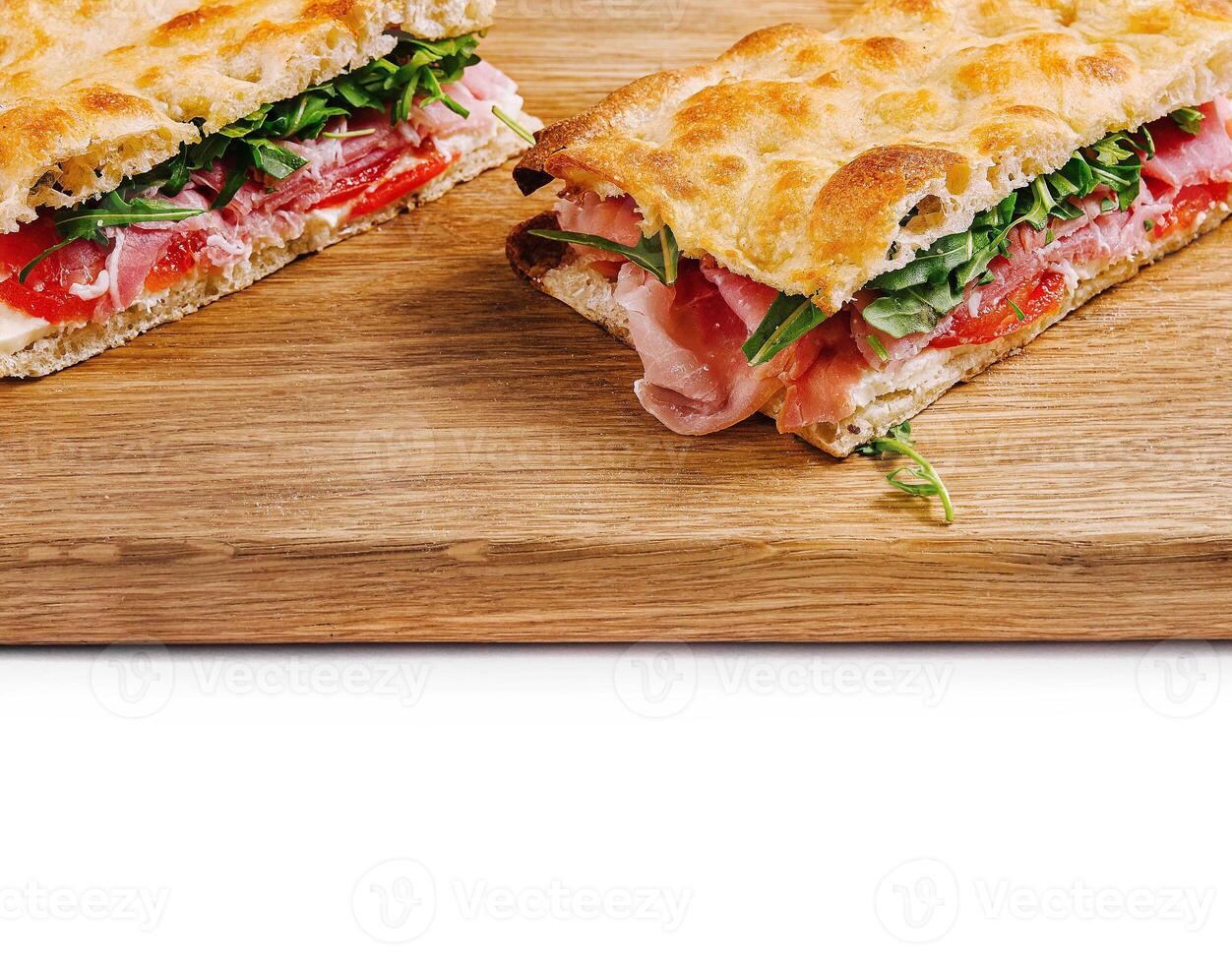 Fresh italian panini sandwich on wooden board photo