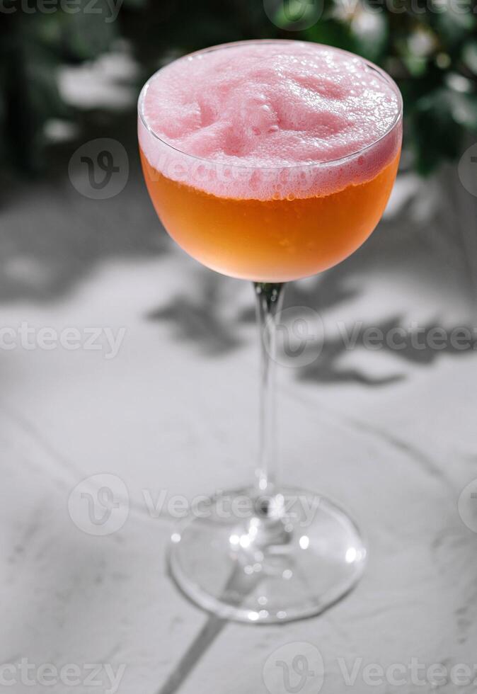 Elegant frothy cocktail on textured surface photo