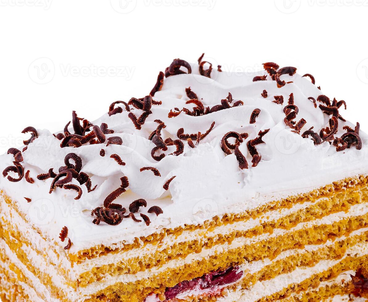 Delicious honey cake decorated with whipped cream and chocolate shavings photo