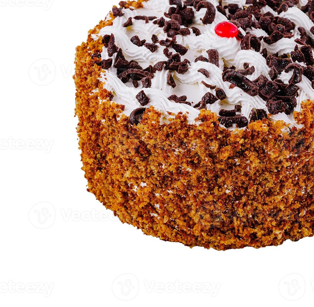 Delicious round cake with chocolate sprinkles and white cream standing on white background photo