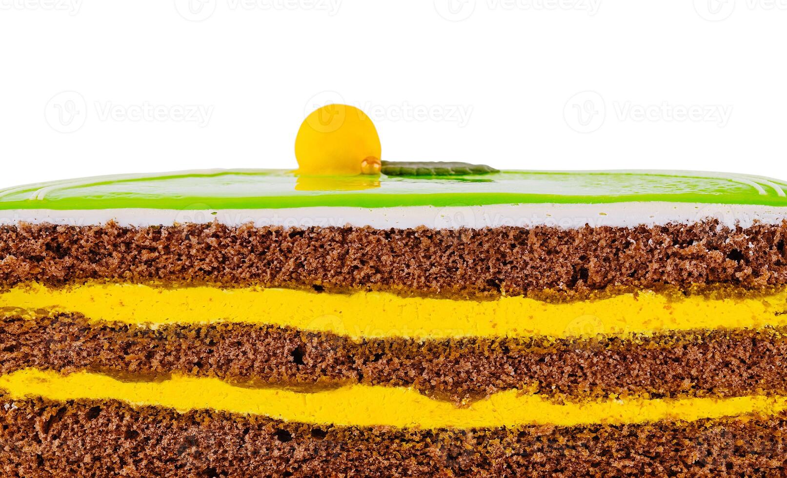 Delicious layered cake with green icing and yellow filling showing texture photo