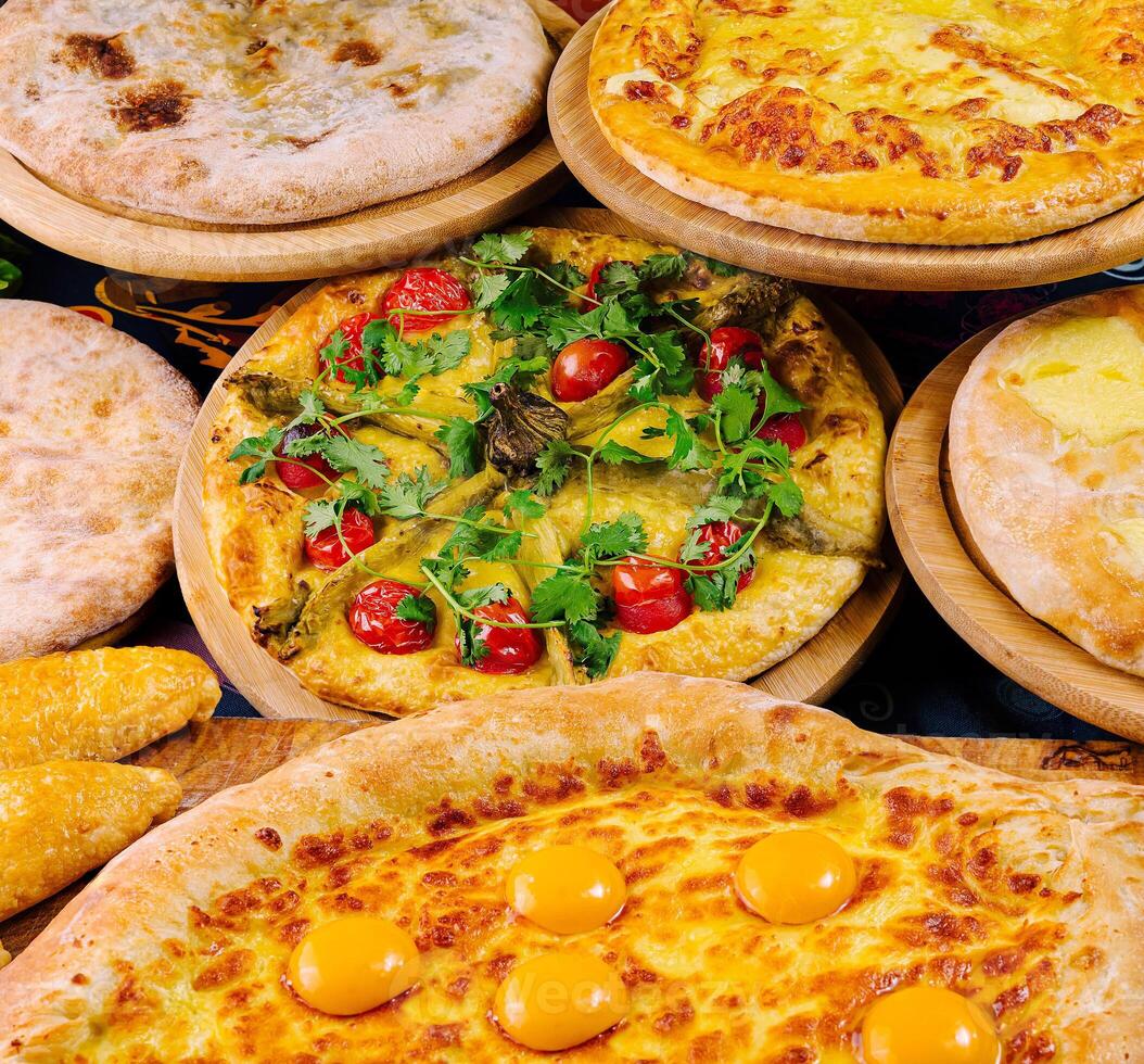 Various georgian dishes lying on wooden plates are waiting for customers in restaurant photo