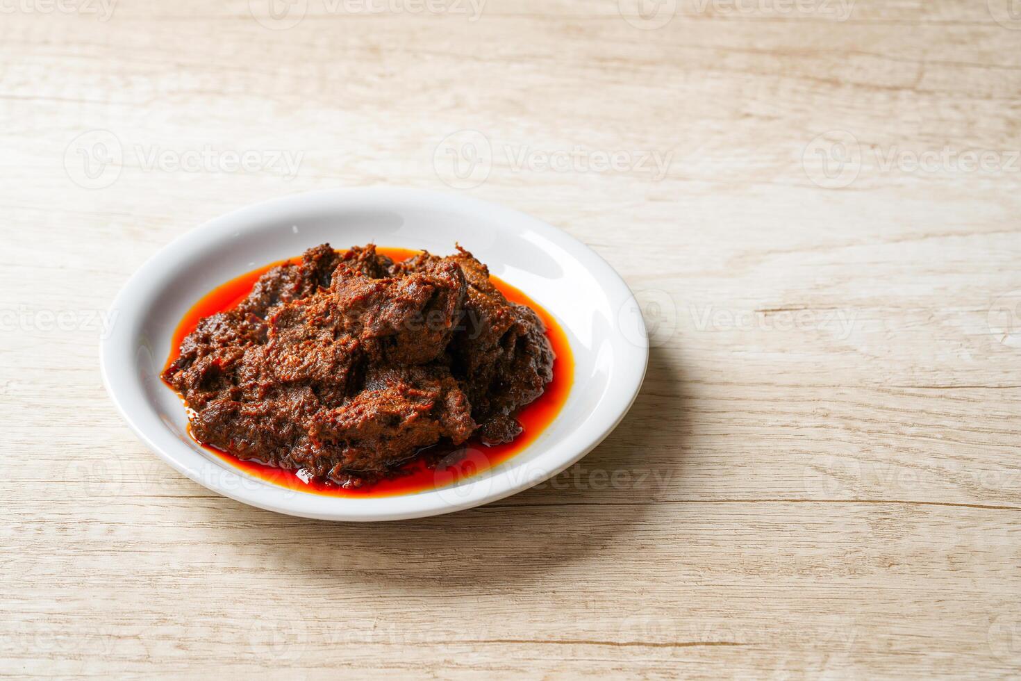 Rendang Pork. Rendang is an Indonesian West Sumatra Minangkabau spicy meat. that slow cooked in coconut milk and mixed spices. photo