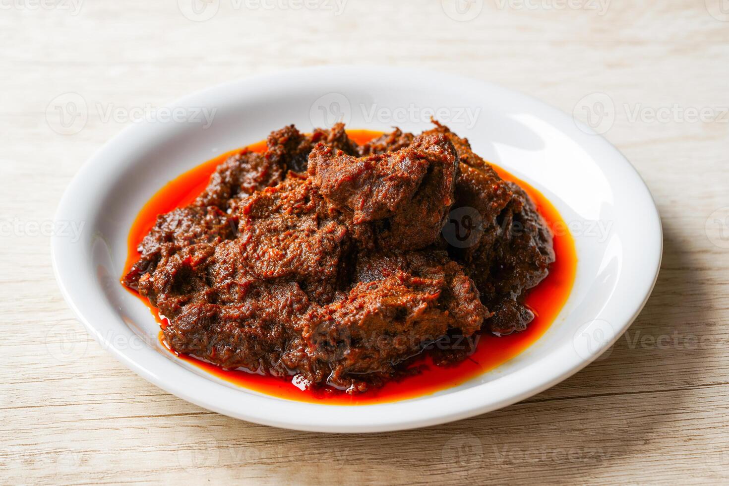 Rendang Pork. Rendang is an Indonesian West Sumatra Minangkabau spicy meat. that slow cooked in coconut milk and mixed spices. photo
