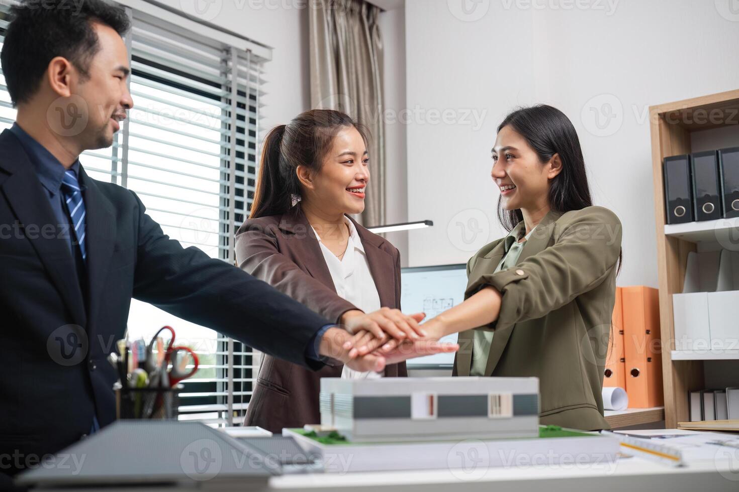 Real Estate Agents Collaborate on Marketing Strategies in Modern Office Setting photo