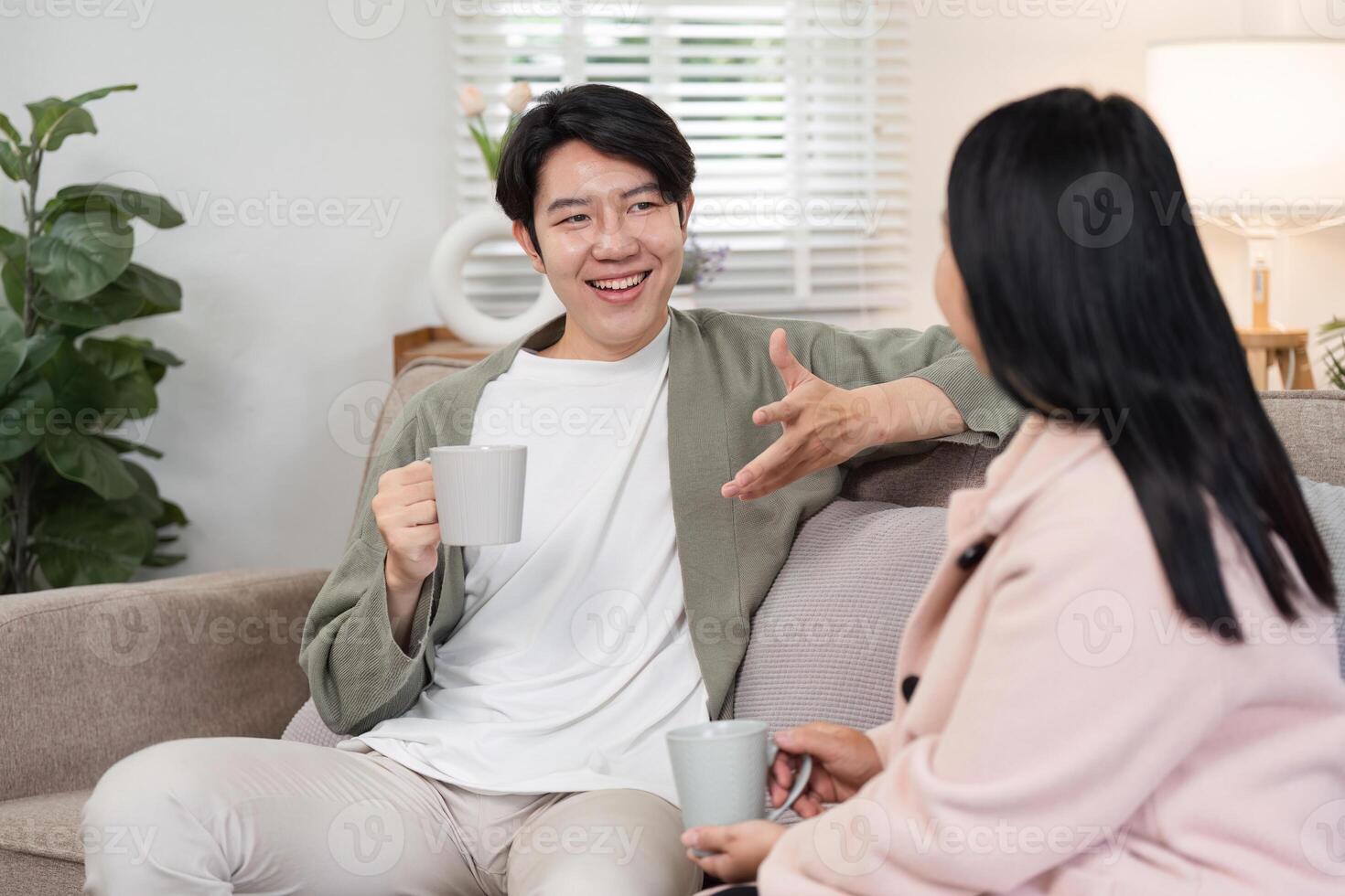 Mother and Son Enjoying Quality Time Together in a Cozy Living Room Setting with Warm Beverages and Relaxed Conversation photo