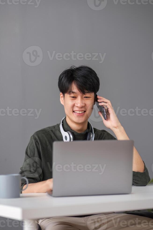 Young Boy Studying Online with Laptop and Headphones, Smiling and Engaged in Virtual Learning at Home photo