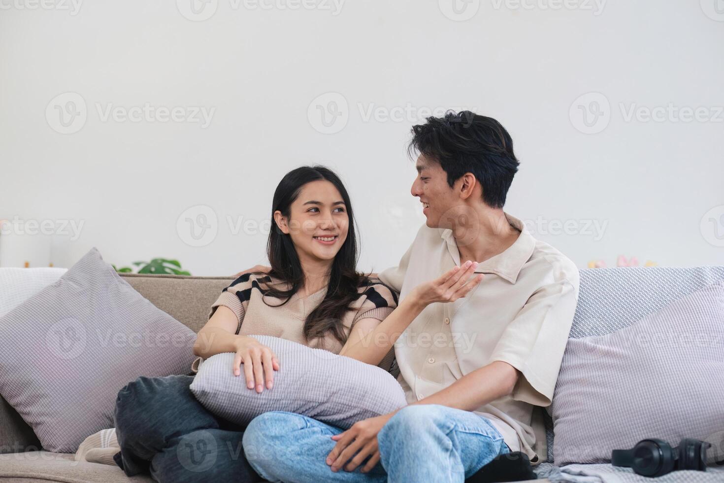 Happy Couple Relaxing on Couch in Modern Home, Enjoying Quality Time Together in Comfortable Living Room Setting photo