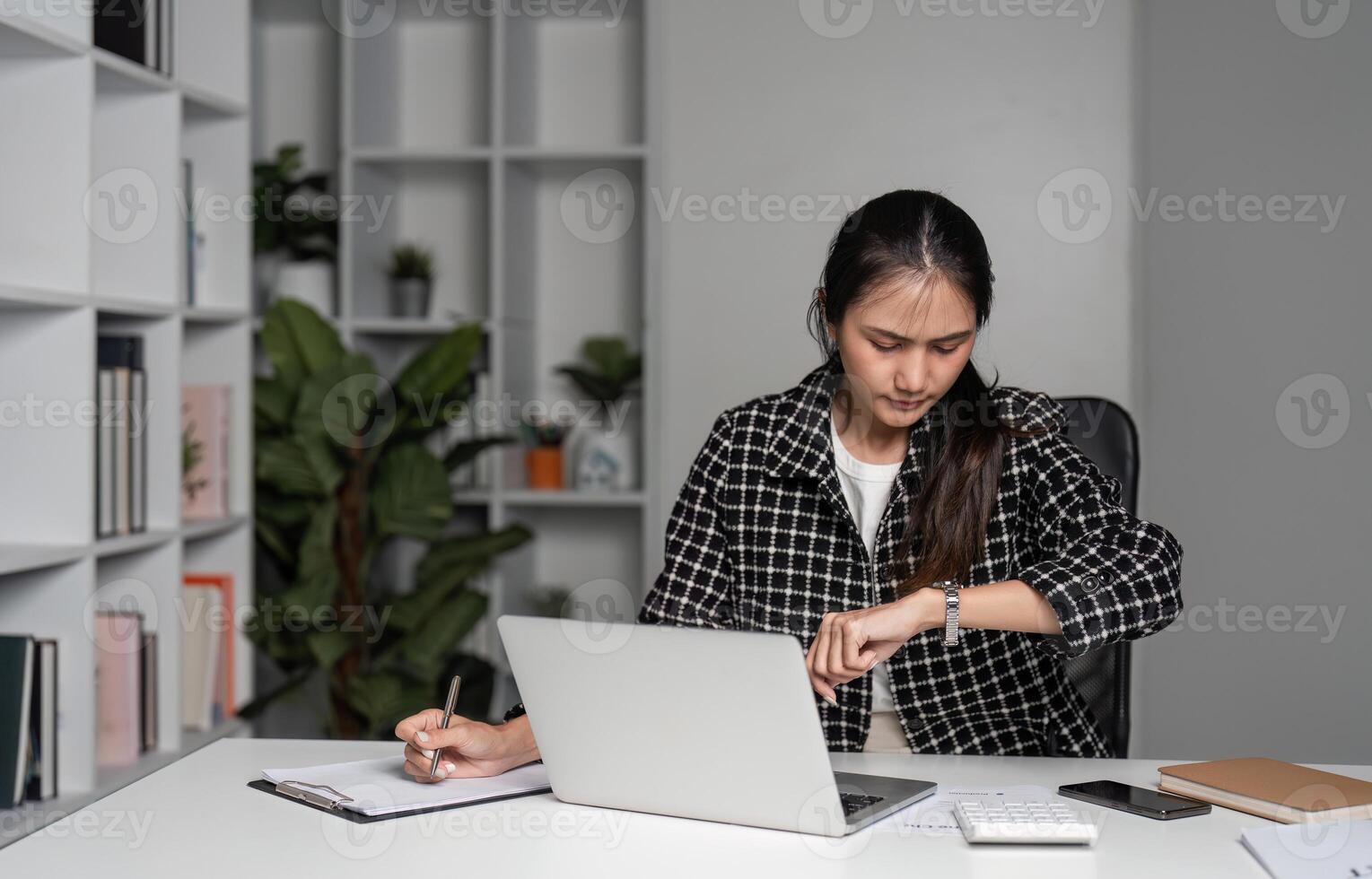 Stressed Business Woman Working Late Hours in Office, Experiencing Exhaustion and Burnout While Managing Deadlines and Tasks photo
