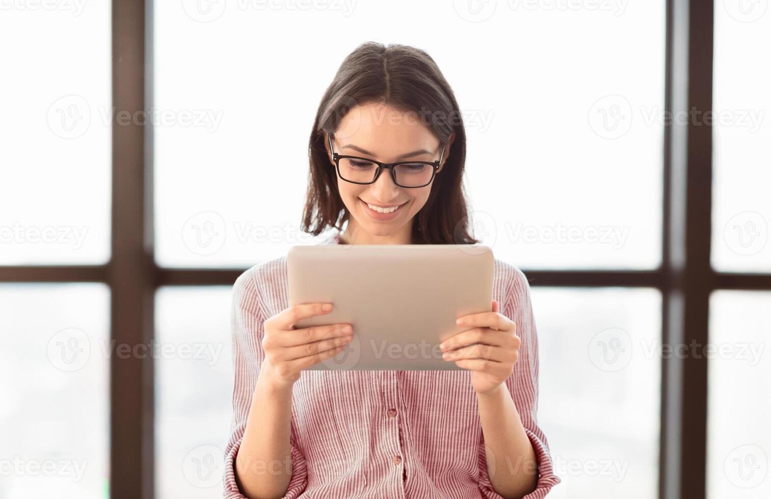 Business App. Young Woman In Glasses Using Tablet And Laptop Computer In Office. Free Space For Text photo