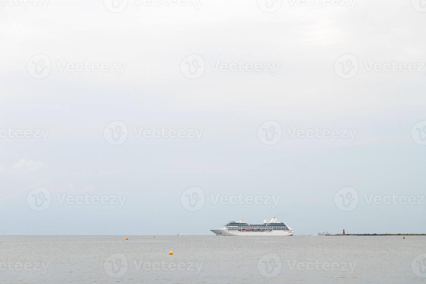 Cruise ship sailing on calm ocean waters with distant horizon. photo
