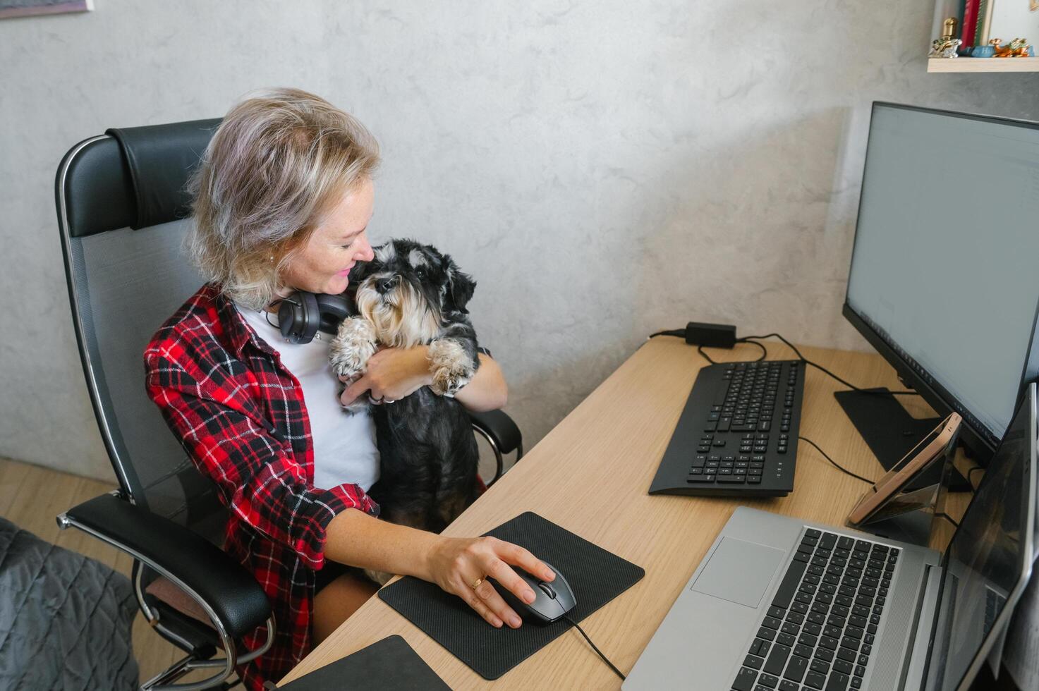 A woman sitting at a desk with a dog photo