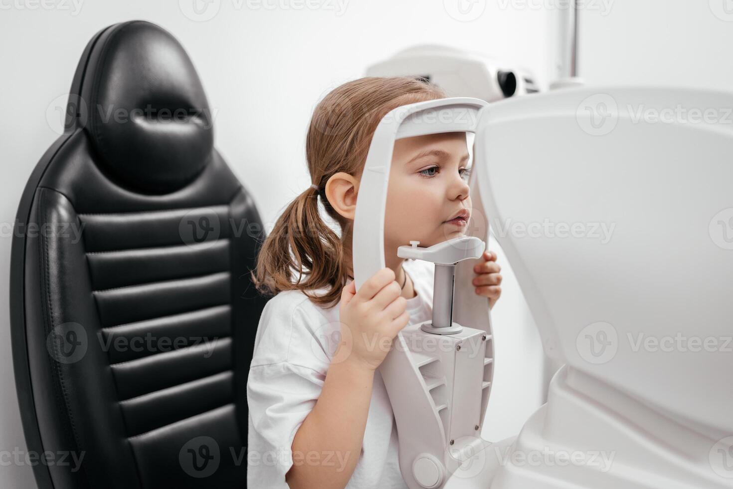 Child little girl getting an eye exam at ophthalmology clinic. Checking retina of a female eye close-up. Laser vision correction. Eyesight concept. Future technology, medicine and vision concept photo
