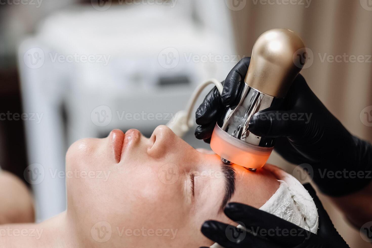A cosmetologist performs RF lifting and ultrasound facial tightening in a modern salon. This advanced treatment rejuvenates and firms skin, perfect for showcasing effective beauty solutions photo