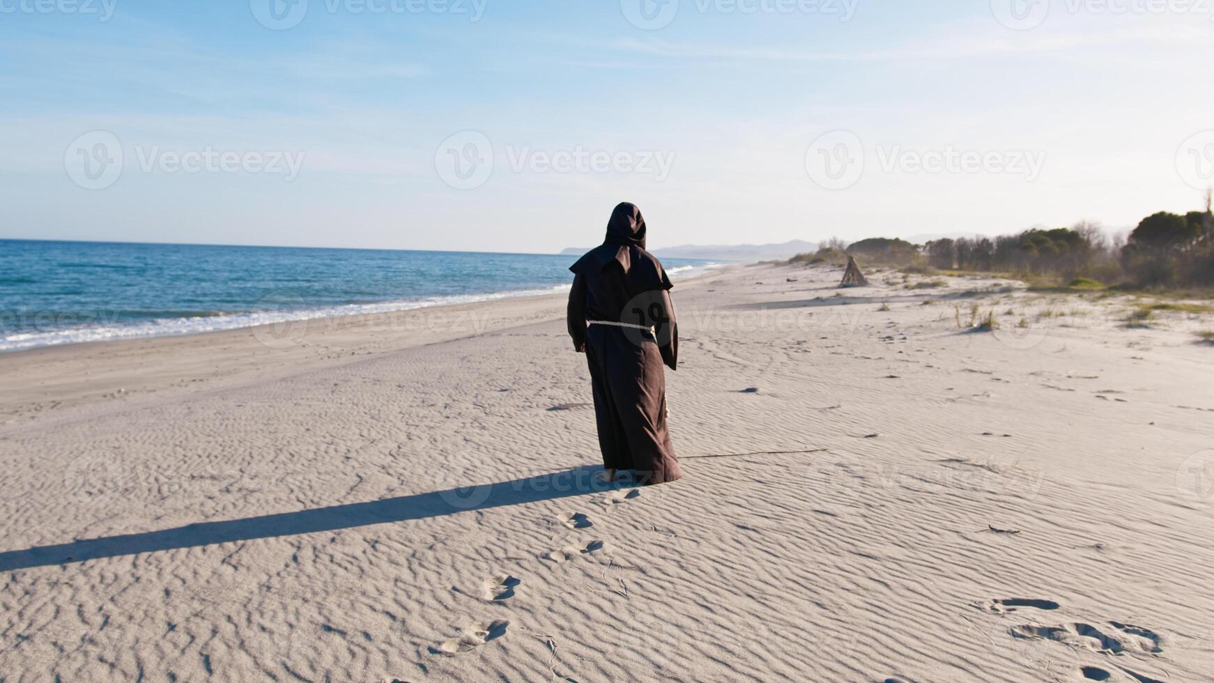 Priest Headed To The Sea Water photo