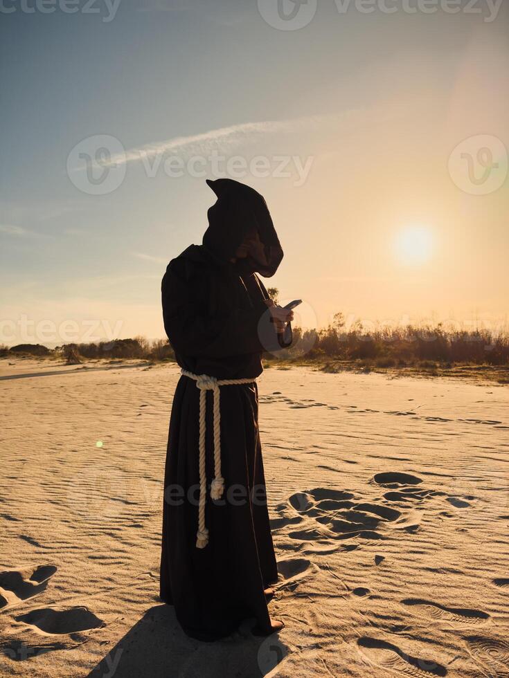 Priest Under The Sun Using The Smartphone photo