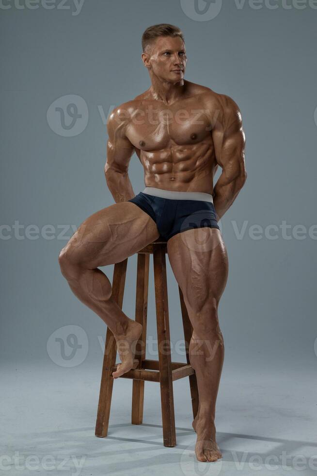 Muscular adult man posing in shorts photo