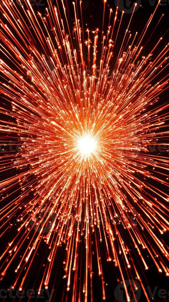 fiery red particles burst from a bright core, spreading outward in a spectacular display across a deep black background, evoking a sense of dynamic energy and heat. photo