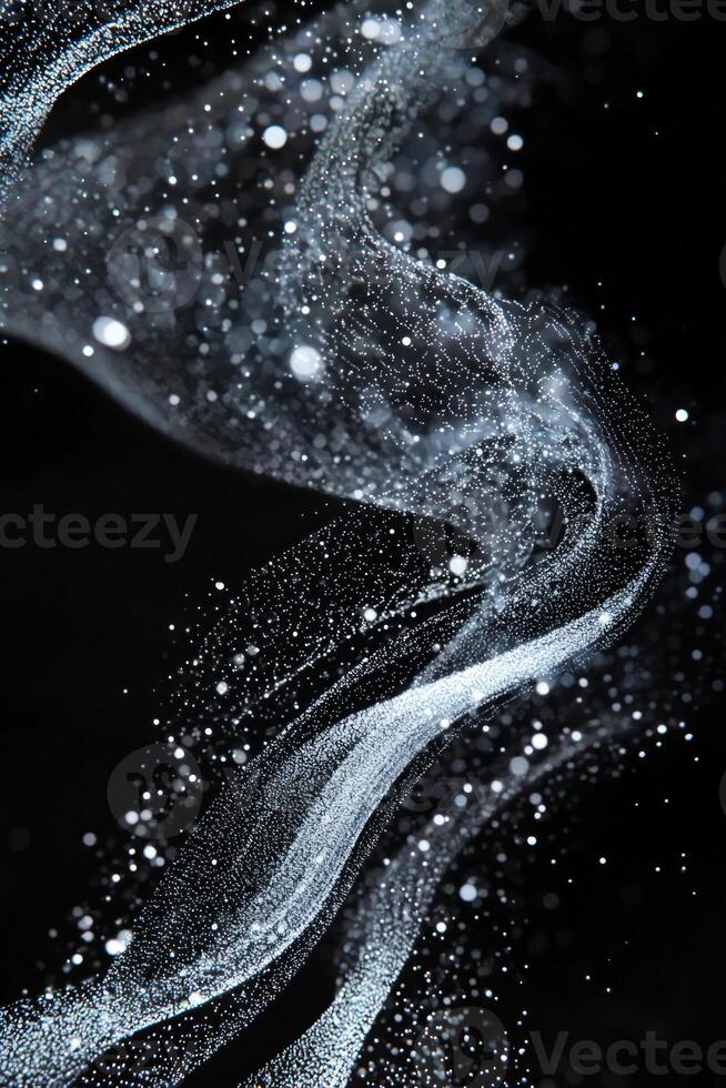 A mesmerizing arrangement of silver dots undulates gracefully, creating a dynamic wave effect on a deep black background, emphasizing motion and fluidity. photo