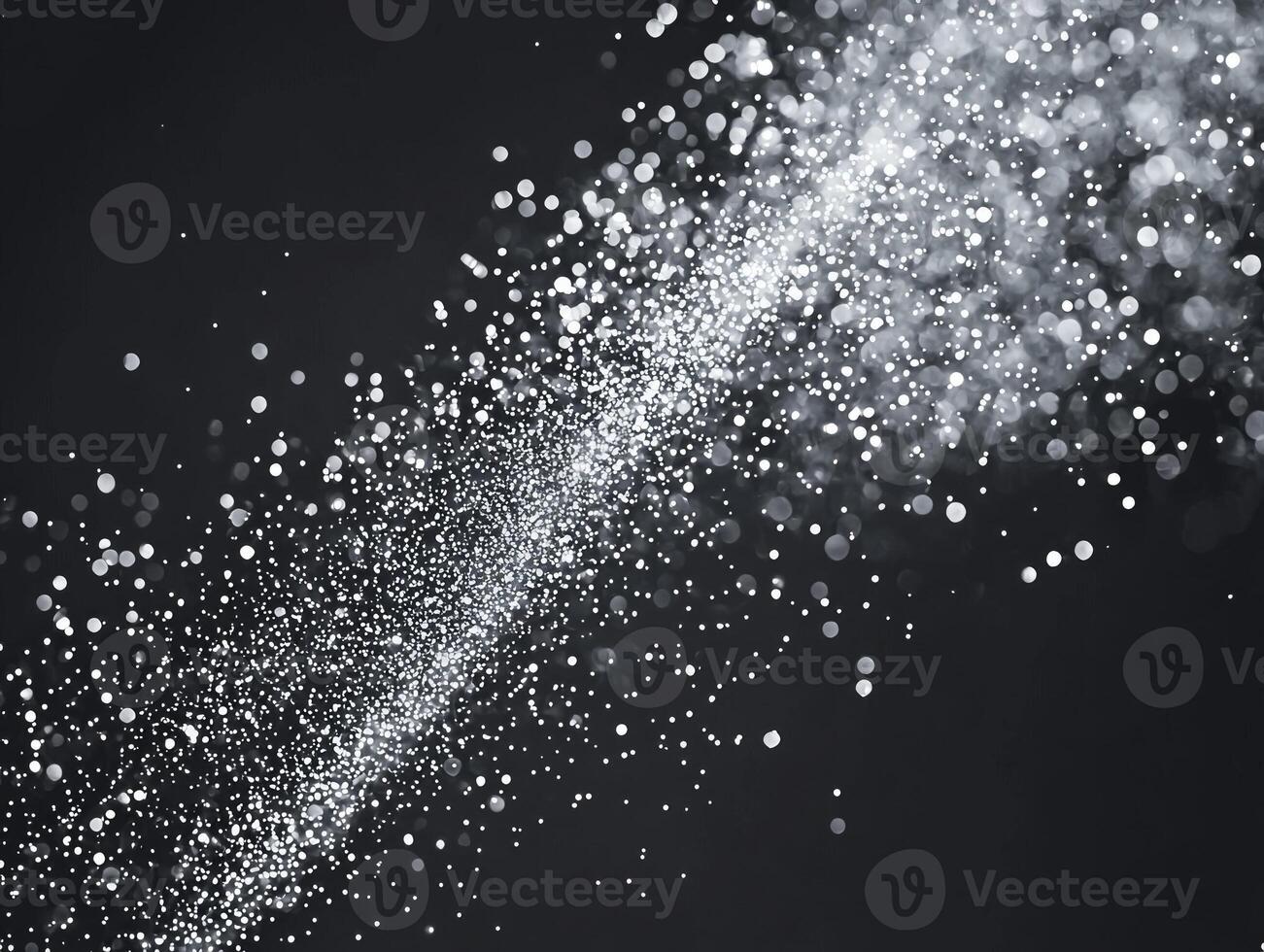 A dynamic scattering of silver particles creates a captivating cosmic effect against a deep black background, reminiscent of twinkling stardust in the universe, alive with energy. photo