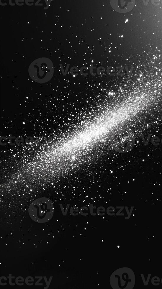 A captivating arrangement of silver particles spirals outward, forming a vortex that creates a stunning contrast against a dark background. The shimmering effect evokes a cosmic energy. photo