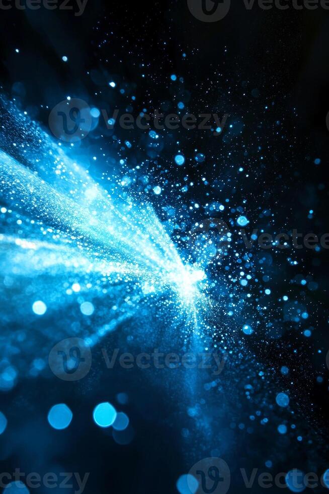 A breathtaking display of blue particles erupts, scattering and glowing with energy. The cosmic affair unfolds against a dark background, igniting imagination and awe. photo