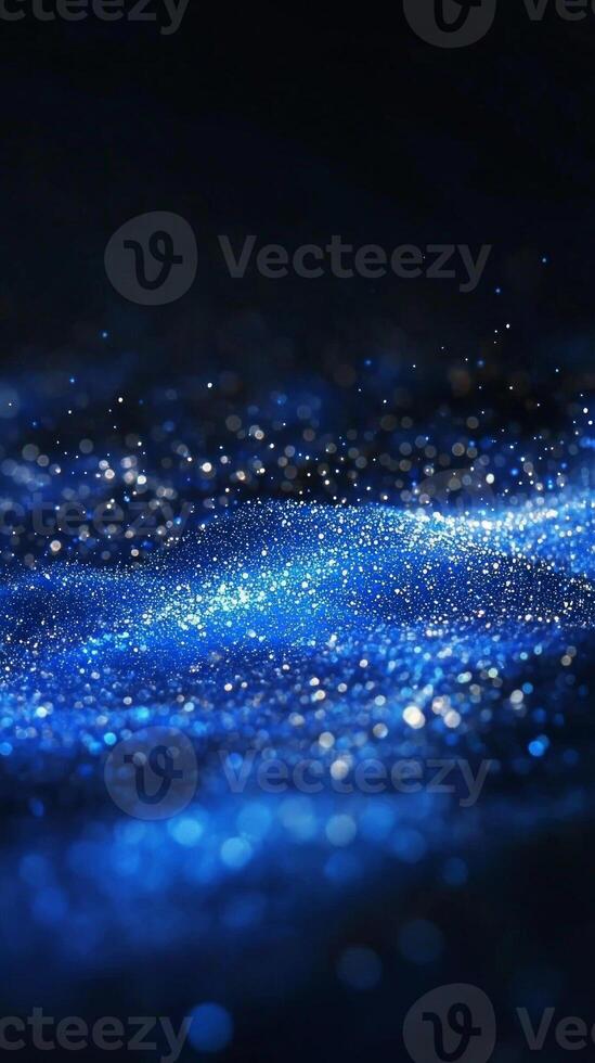A breathtaking display of blue particles bursts into radiant waves, casting an ethereal glow through the darkness, resembling a cosmic phenomenon full of shimmering beauty. photo
