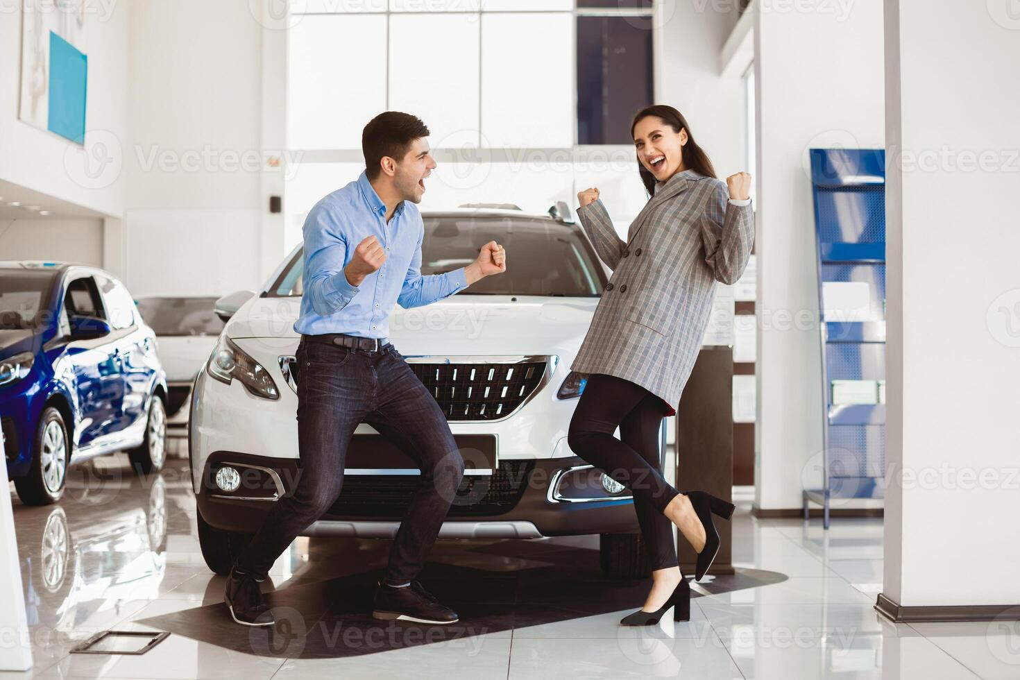 Successful Visit To The Dealership. Happy young caucasian couple buying new car for their young family photo