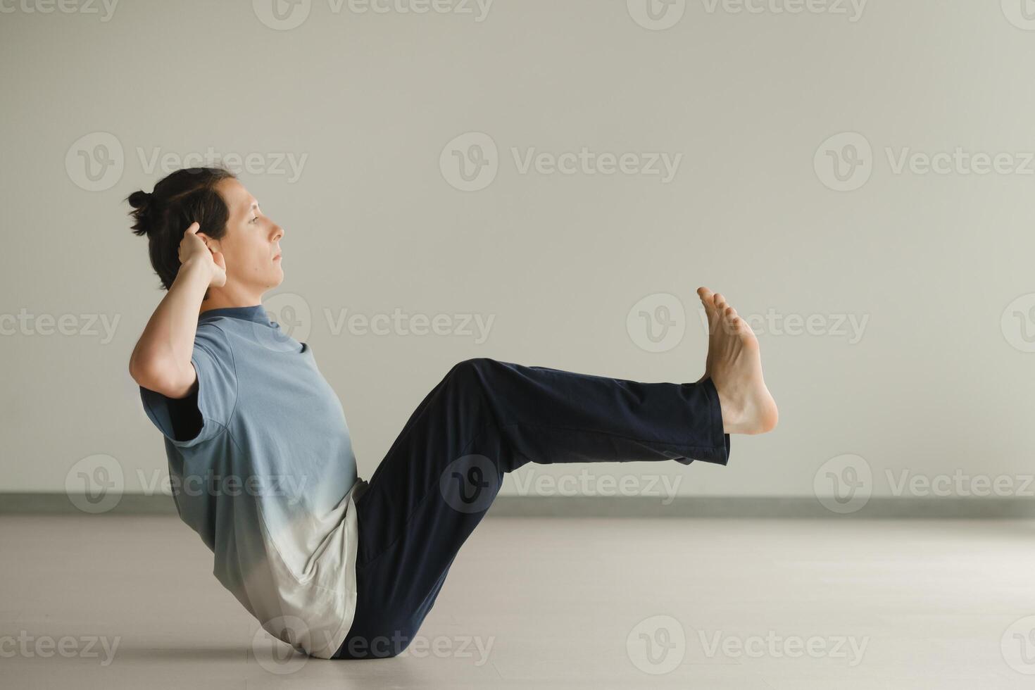 a man in a sports uniform does yoga in a fitness room. the concept of a healthy lifestyle photo