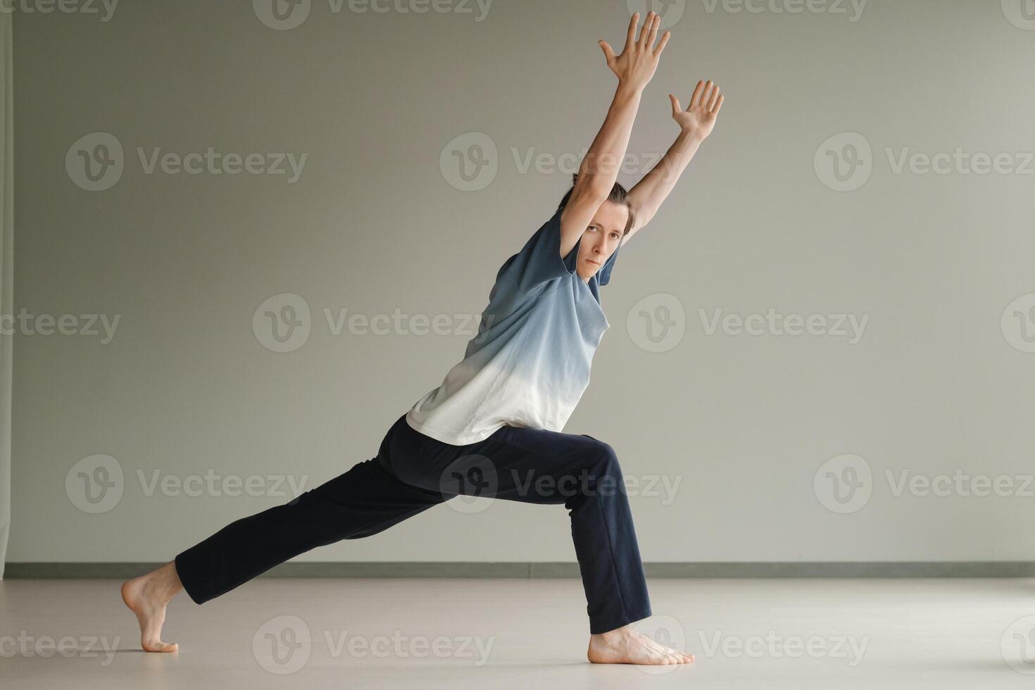 a man in a sports uniform does yoga in a fitness room. the concept of a healthy lifestyle photo