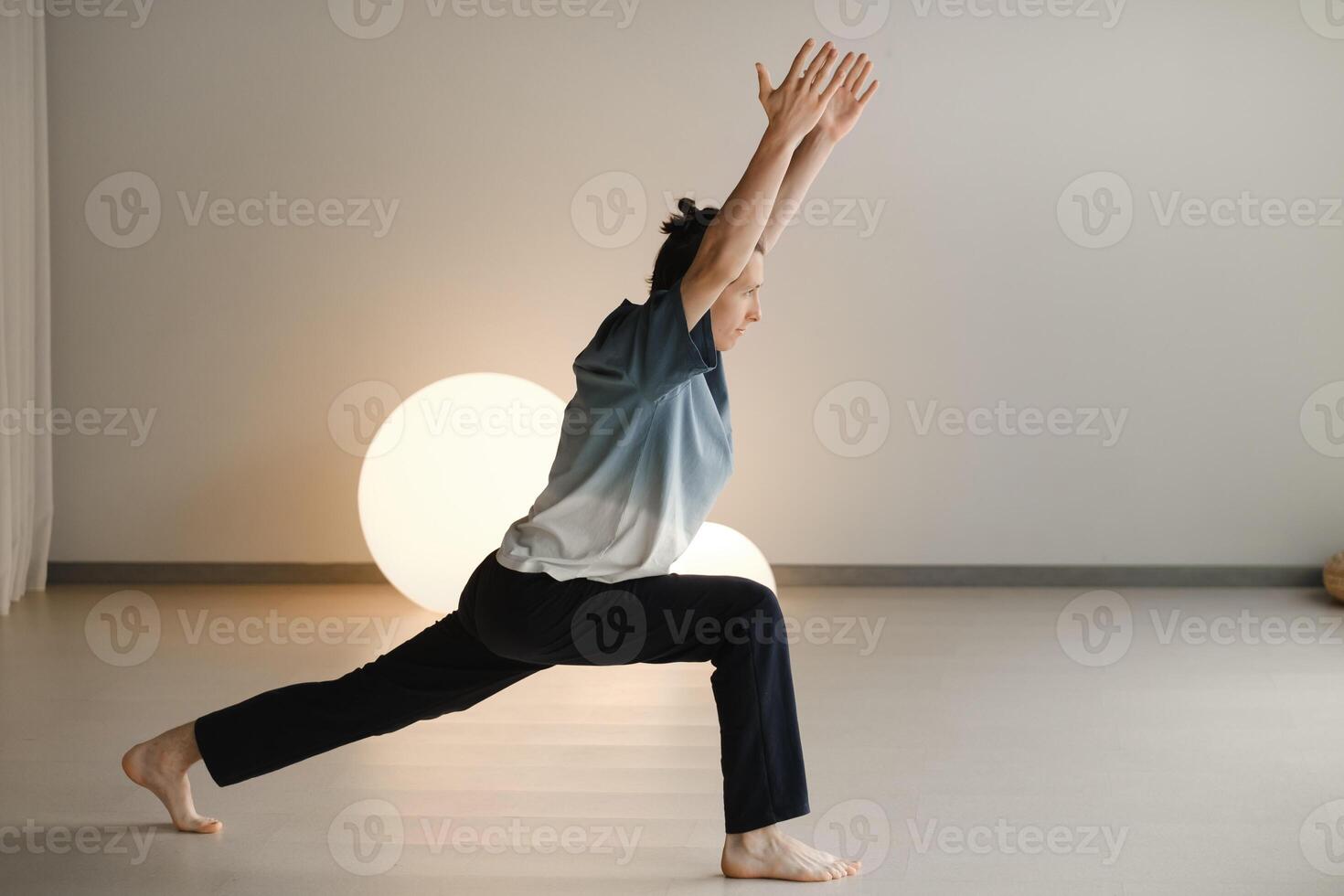 a man in a sports uniform does yoga in a fitness room. the concept of a healthy lifestyle photo