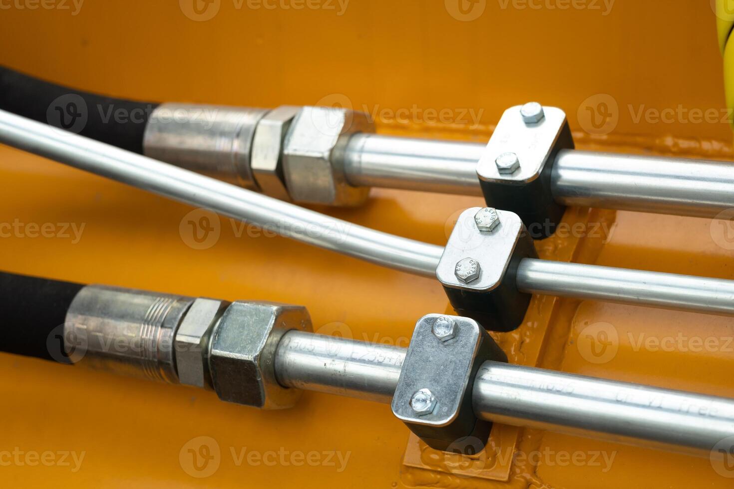 Close-up of an assembly with hydraulic pipes and couplings on a truck photo